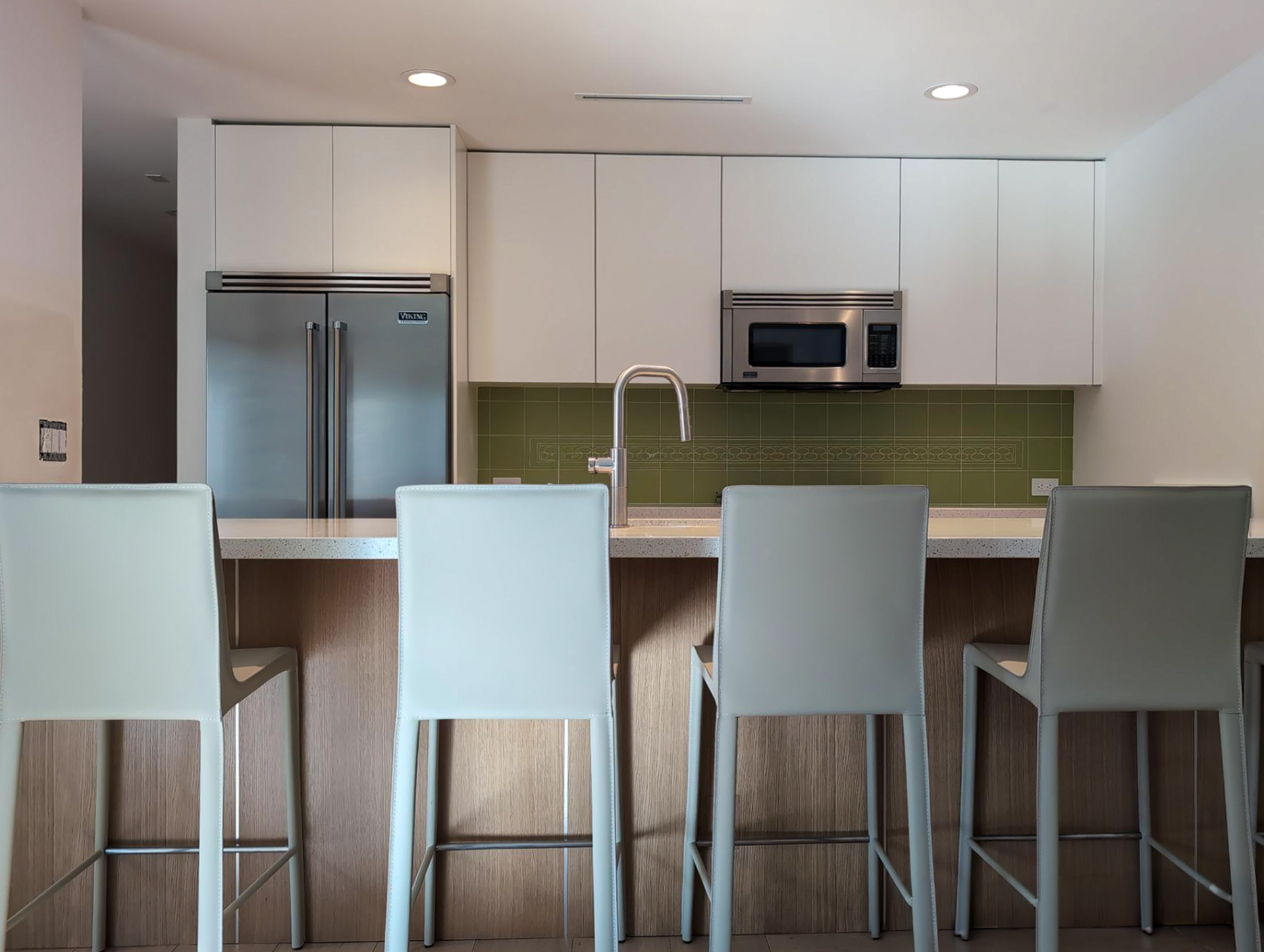 Palm Springs Living & Kitchen Remodel — kitchen with full-length oak island, five bar stools, Viking appliances and sage green tile backsplash