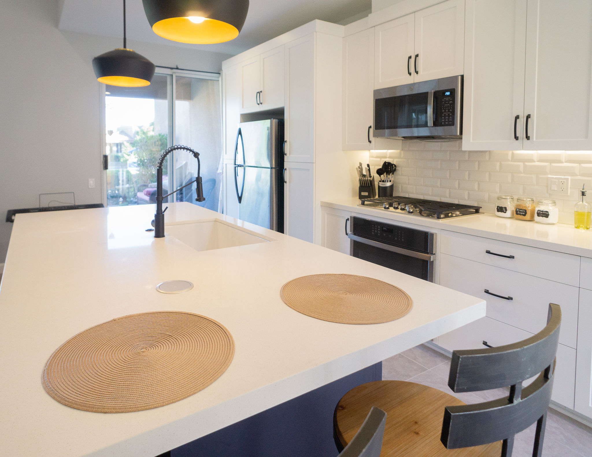 Palm Desert Whole-Home Renovation — kitchen island close-up with quartz countertop and industrial bar stools