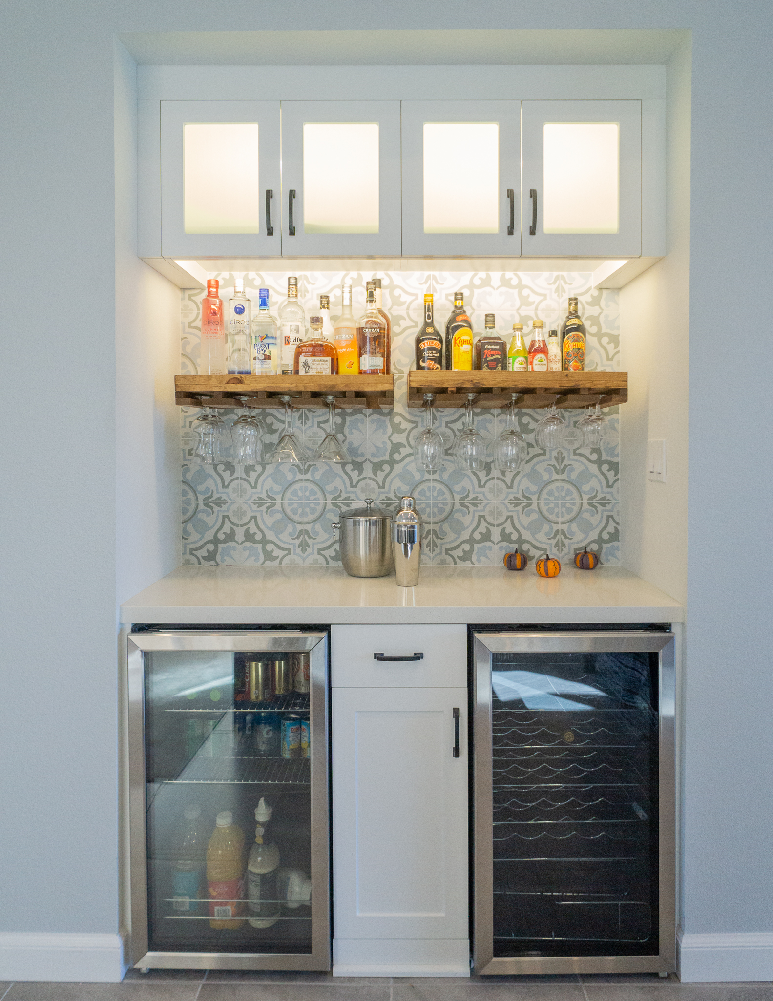 Palm Desert Whole-Home Renovation — custom built-in bar with cement tile, lit cabinetry, wine and beverage fridges