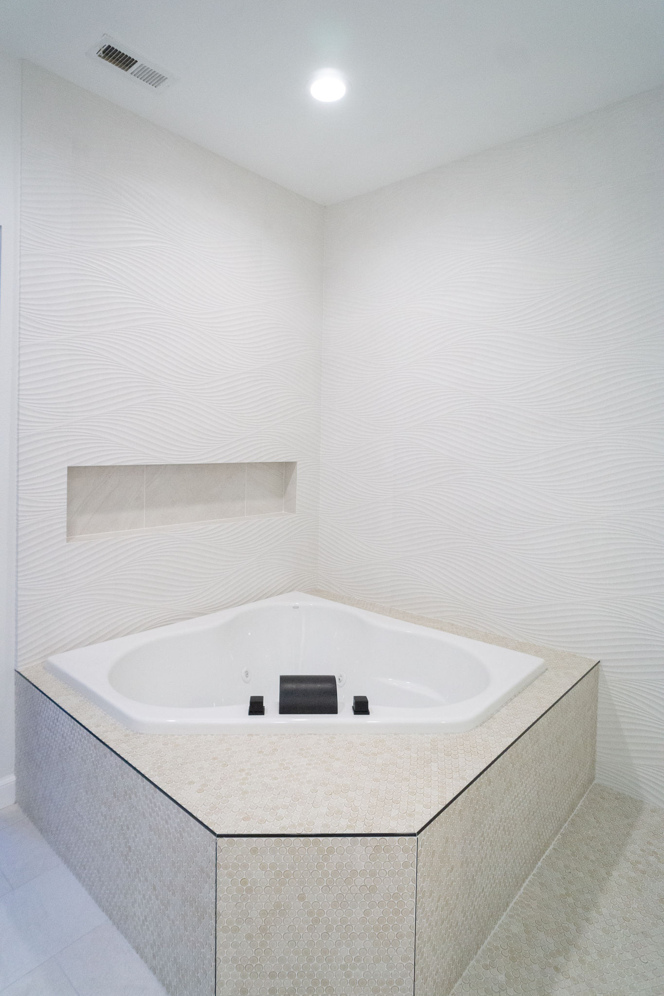 Palm Desert Whole-Home Renovation — corner soaking tub with wave tile surround and built-in niche