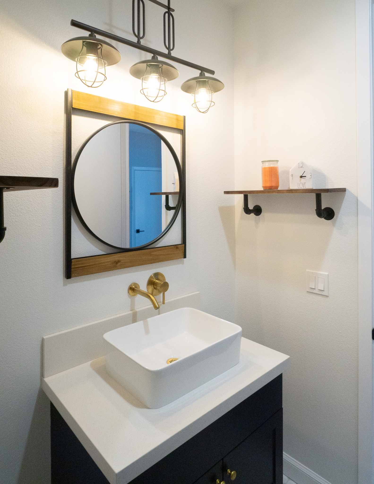 Palm Desert Whole-Home Renovation — powder bath with vessel sink, gold wall faucet, industrial cage lights