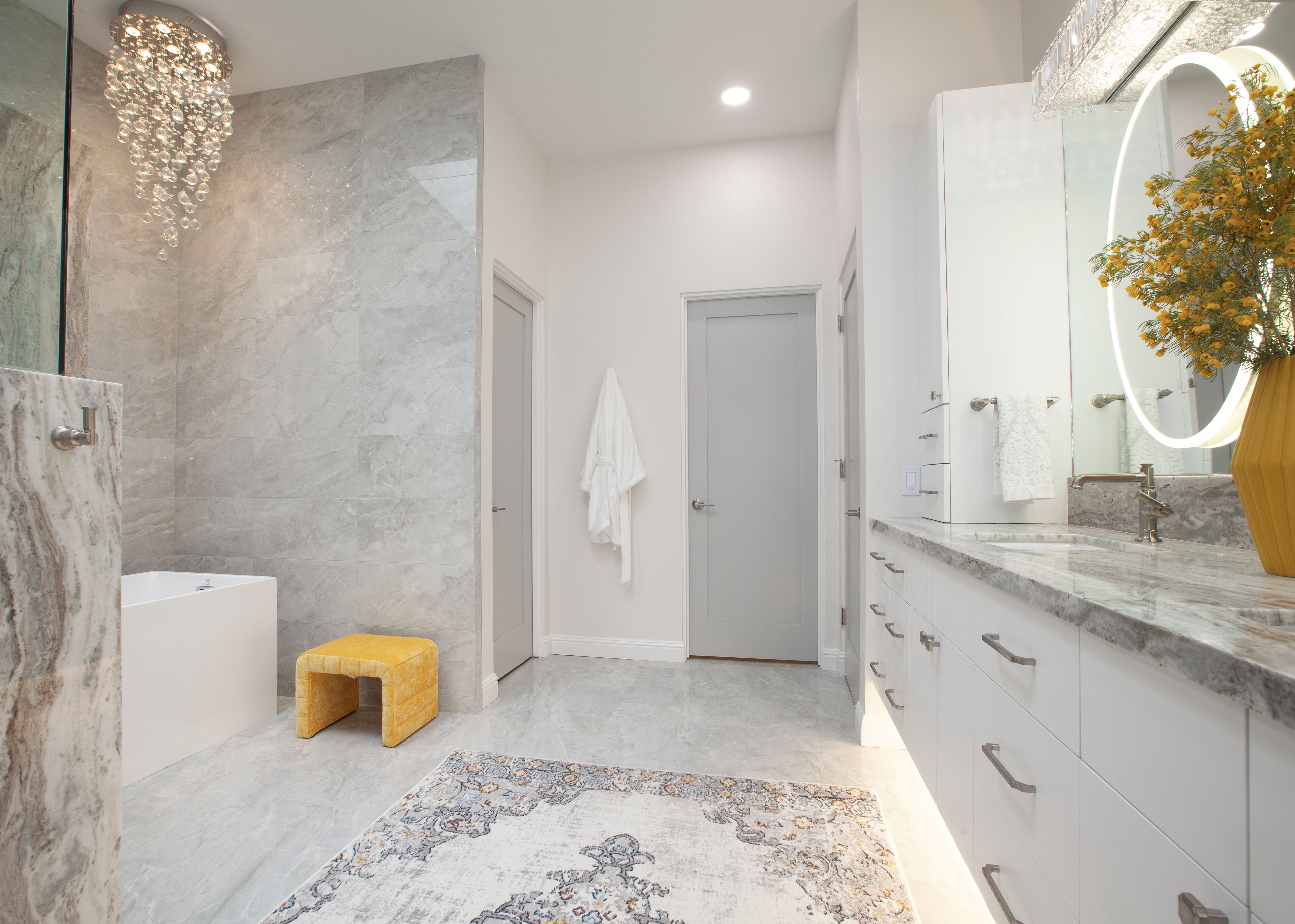 Room Addition & Whole-Home Renovation — spa master bath with crystal chandelier, freestanding soaking tub, marble tile