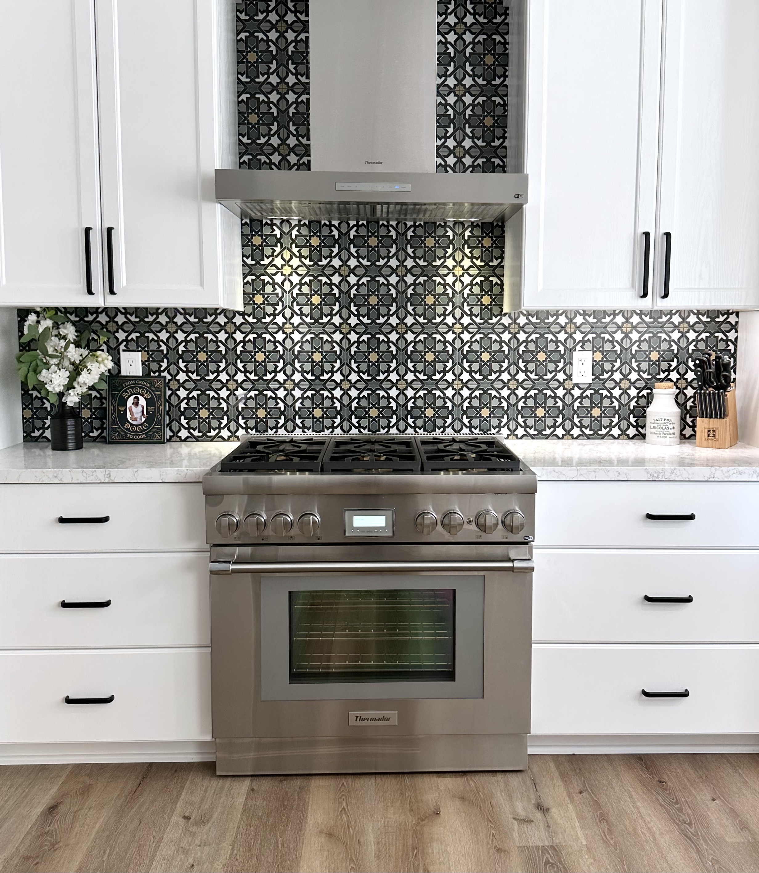 Kaplan Rosen kitchen — custom cabinetry, Moroccan tile, bifold doors to desert