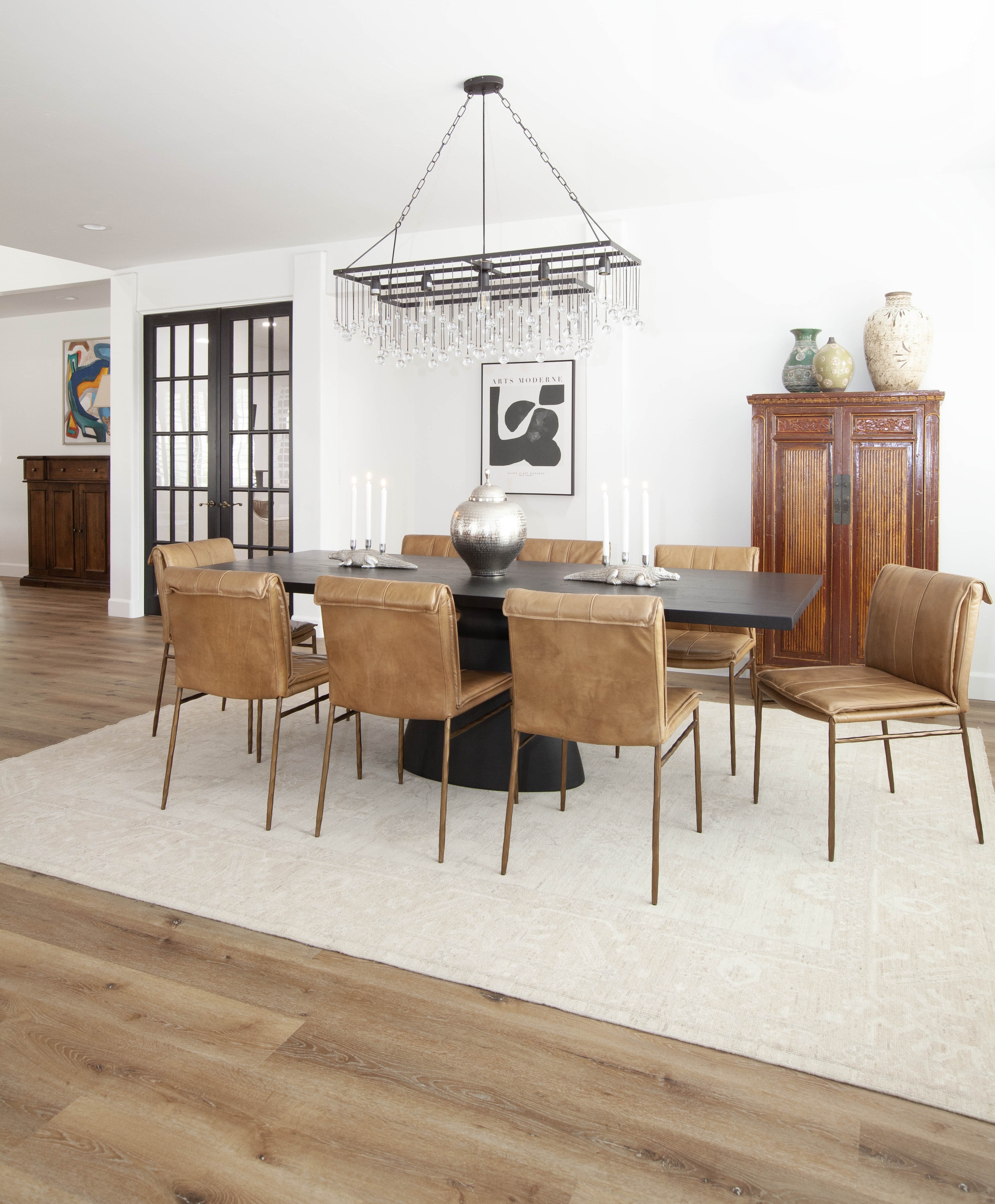 Room Addition & Whole-Home Renovation — dining room with leather chairs, crystal chandelier, antique armoire