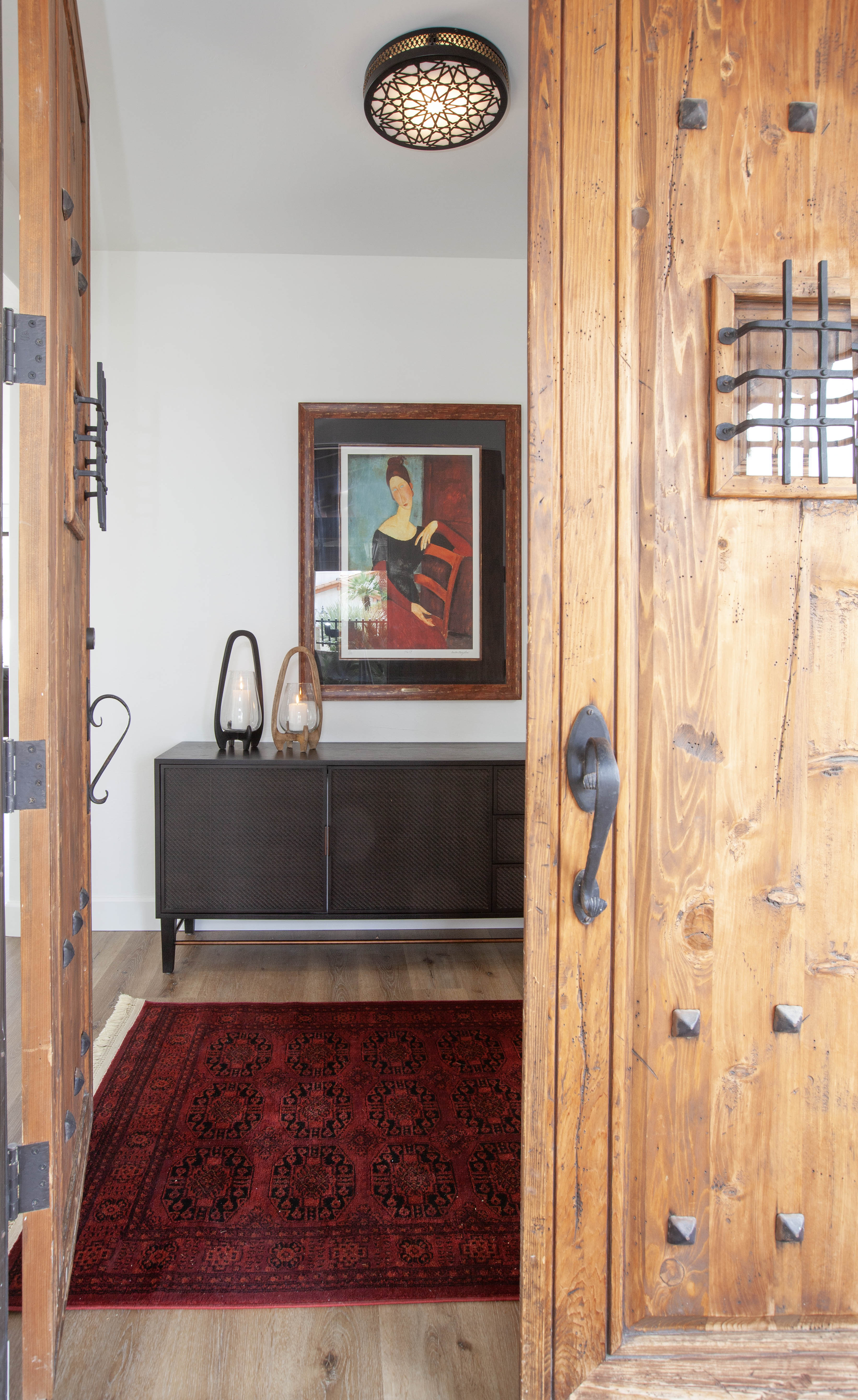 Room Addition & Whole-Home Renovation — framed through rustic wood front door looking into the home