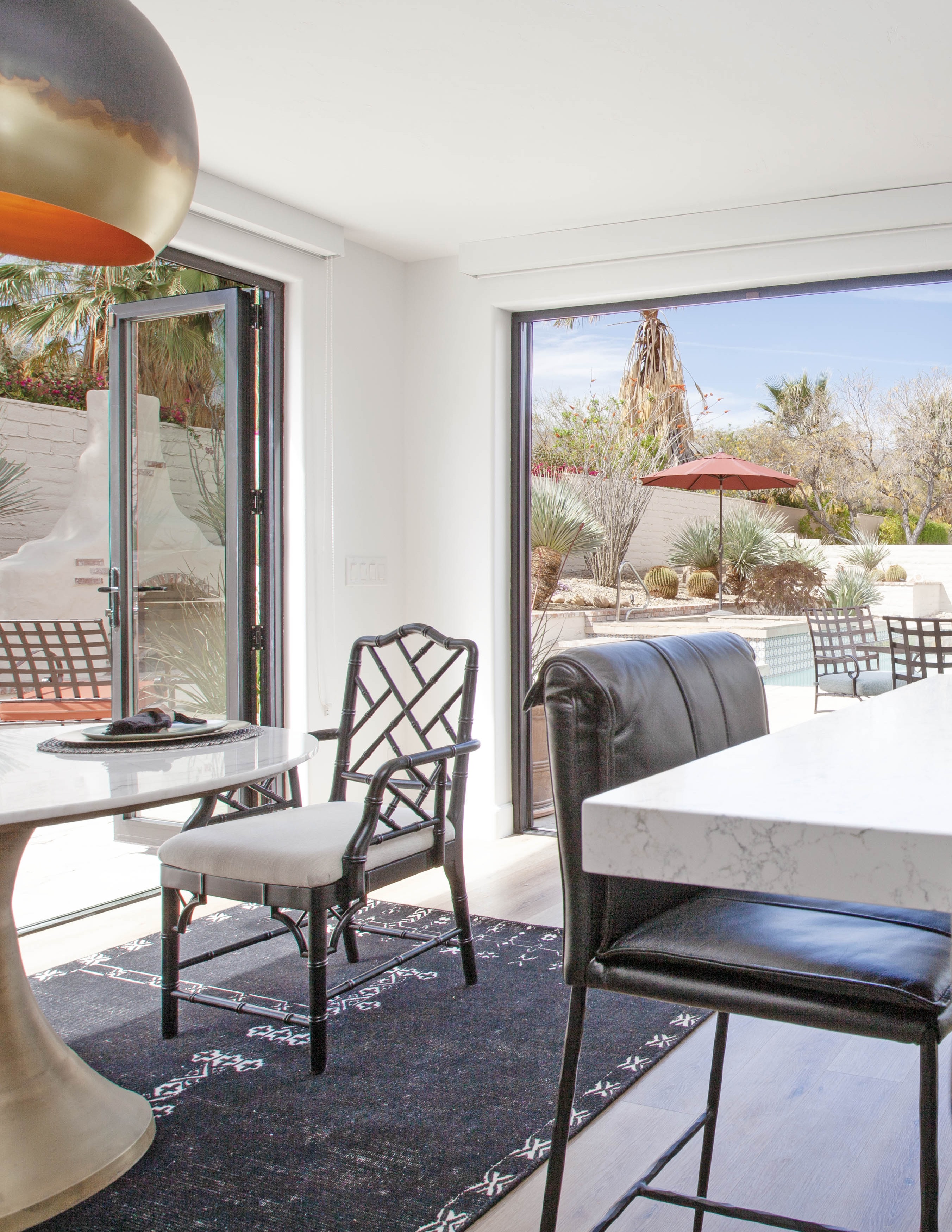 Room Addition & Whole-Home Renovation — kitchen with bifold doors open showing pool patio