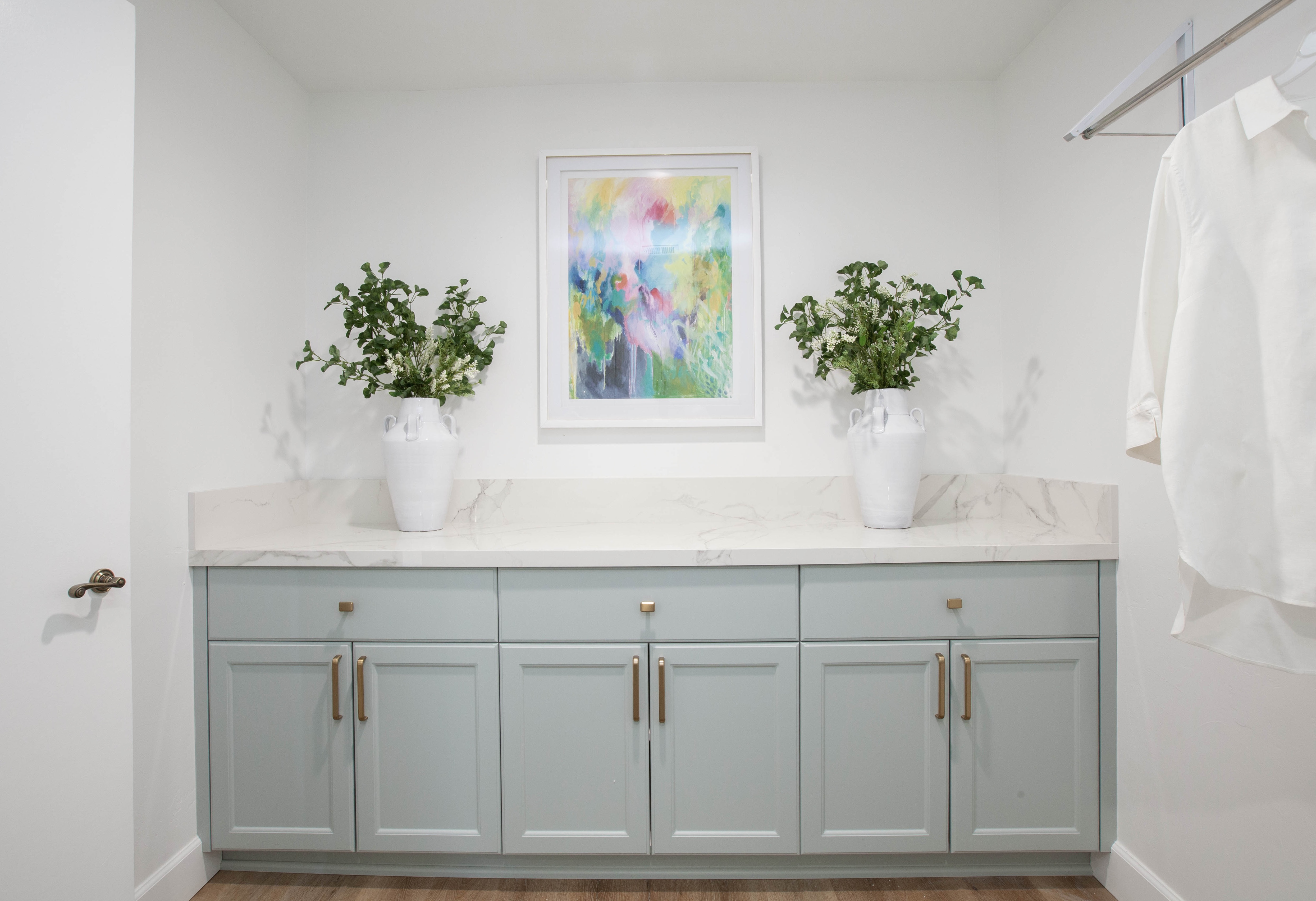 Room Addition & Whole-Home Renovation — marble laundry counter with plants and art