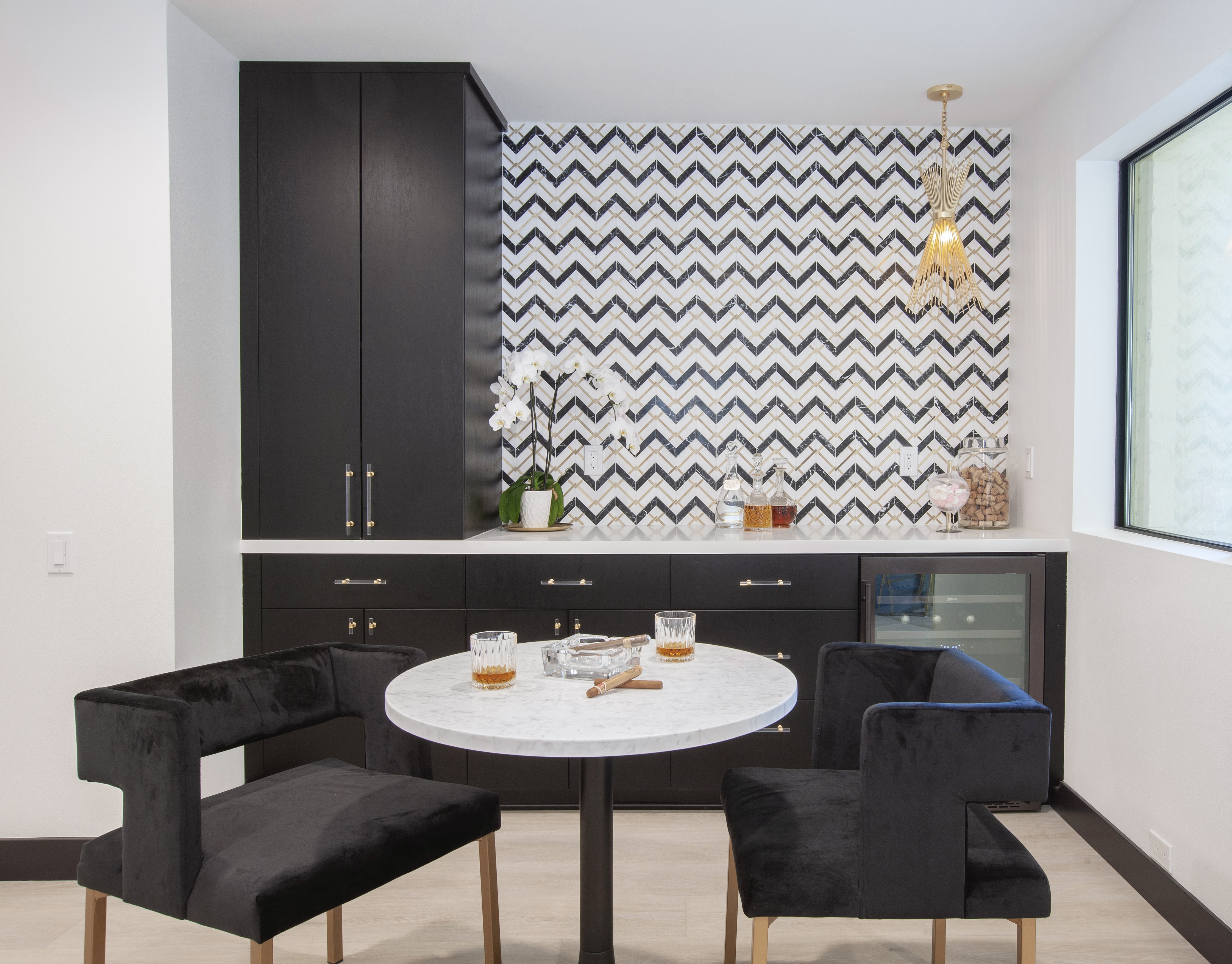 Desert Horizons Residence — bold chevron tile feature wall with velvet chairs and marble tulip table