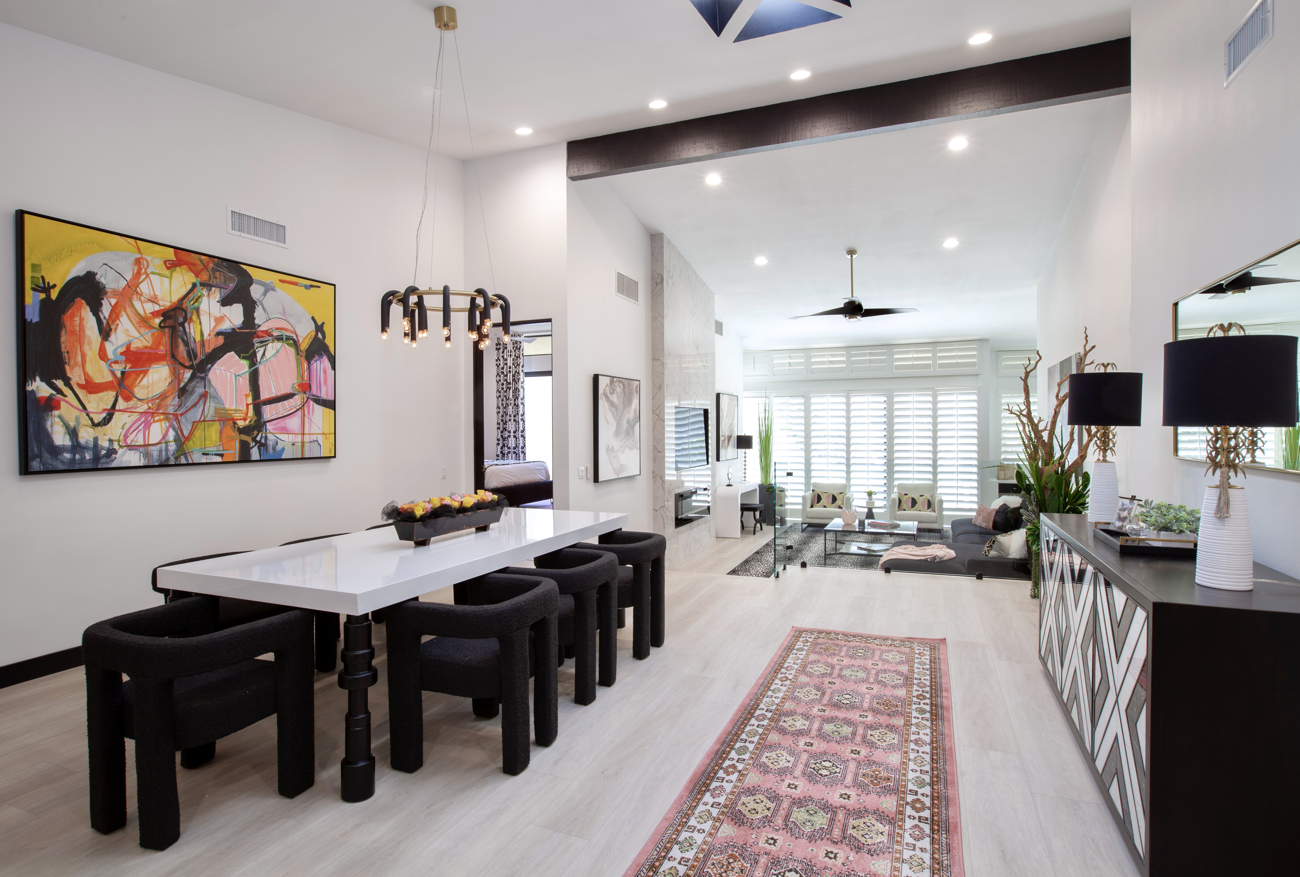 Desert Horizons Residence — dining room with long table, abstract art, view through to living room