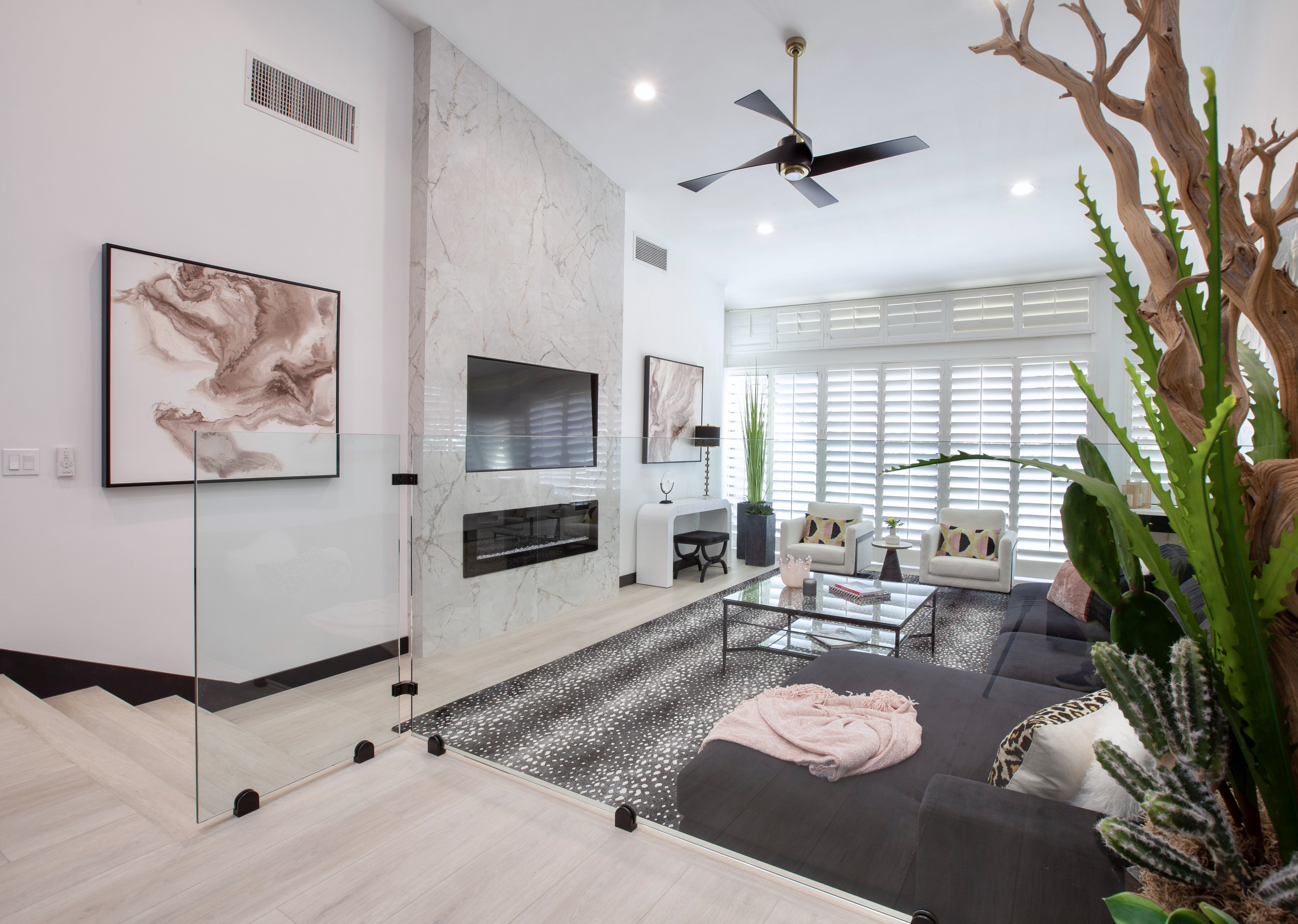 Desert Horizons Residence — marble feature fireplace wall, soaring ceilings, natural plants framing