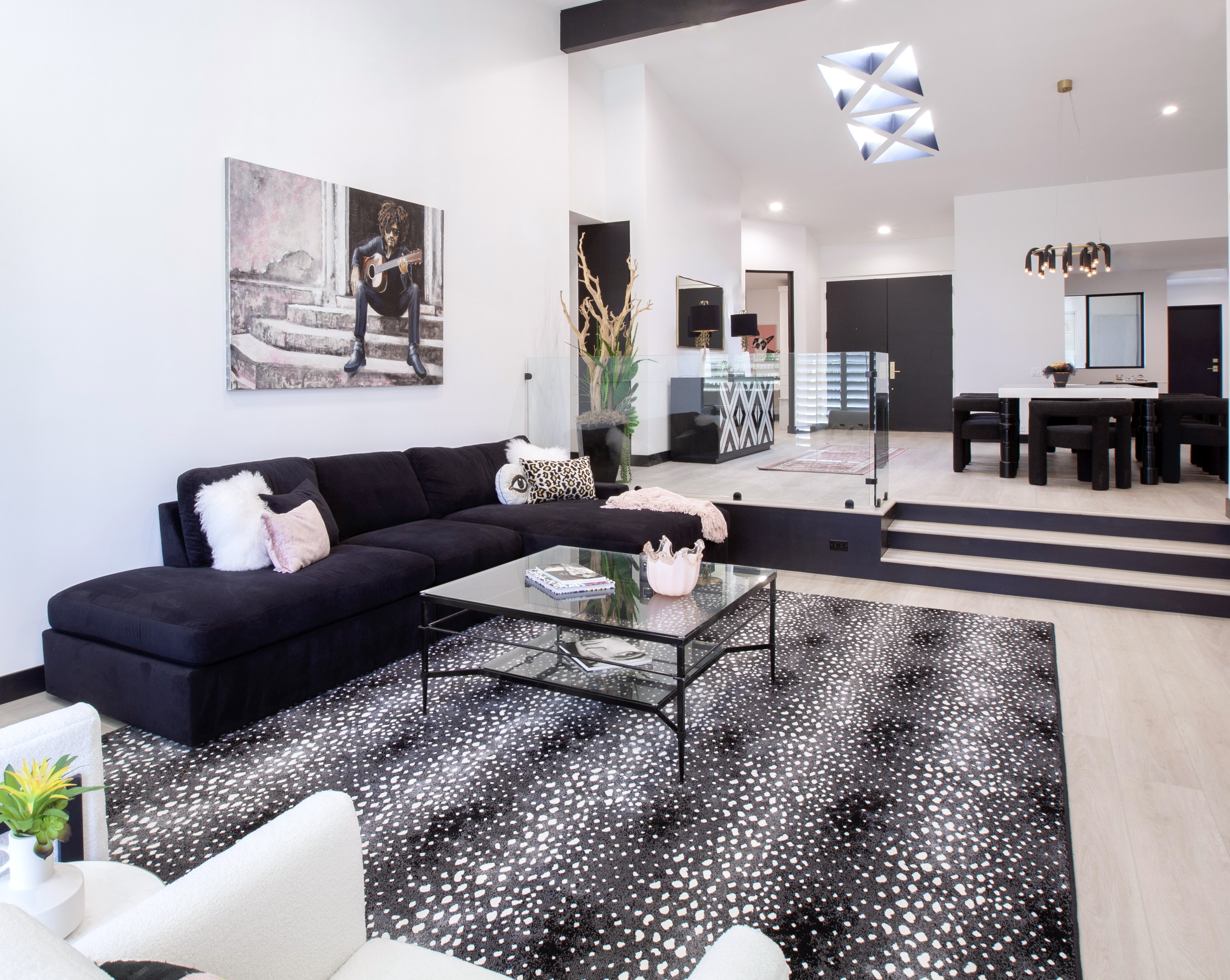 Desert Horizons Residence — wide living room with sectional, glass stair rail, open plan