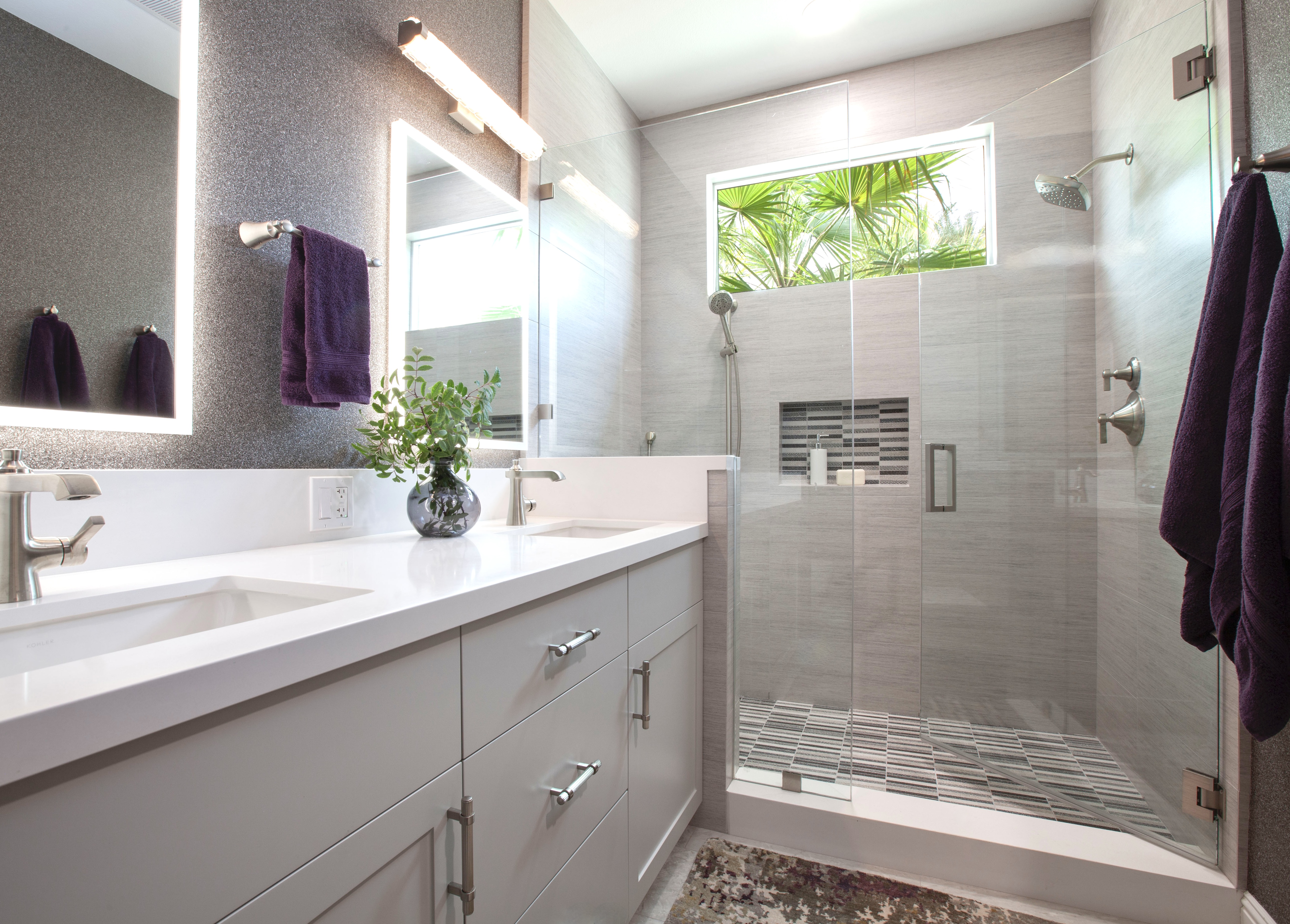 Multi-Bathroom Renovation — gray tile bath with garden window showing palm tree and natural light